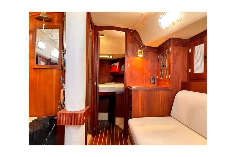 Slide: The Image of 1981 Jensen Marine Cal 39 MK III yacht interior with wooden cabinetry and cozy seating. - 32