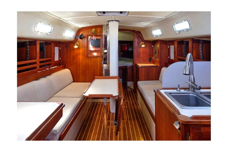 Slide: The Image of Interior of 1981 CAL 39 MK III sailboat with wood finish and cozy seating area. - 35
