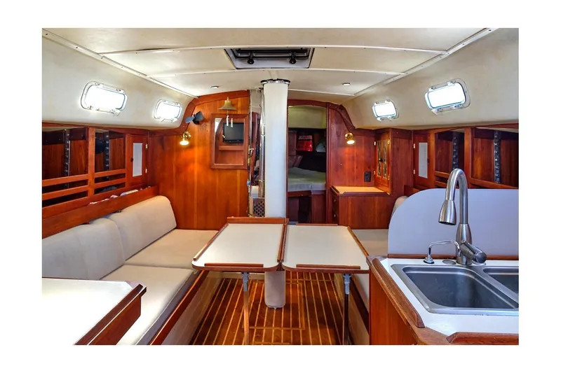 Slide: The Image of Interior of 1981 CAL 39 MK III sailboat with wood finish and cozy seating area. - 36