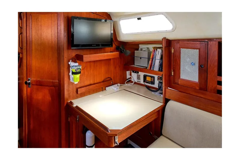 Slide: The Image of 1981 CAL 39 MK III yacht interior with navigation station, wooden cabinetry, and mounted TV. - 37
