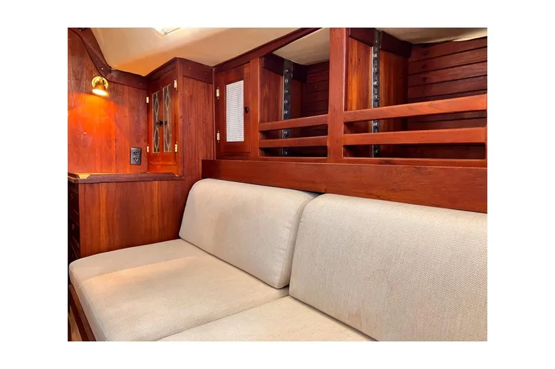 Slide: The Image of 1981 Jensen Marine/Cal Boats 39 MK III interior with wooden cabinetry and beige seating. - 48