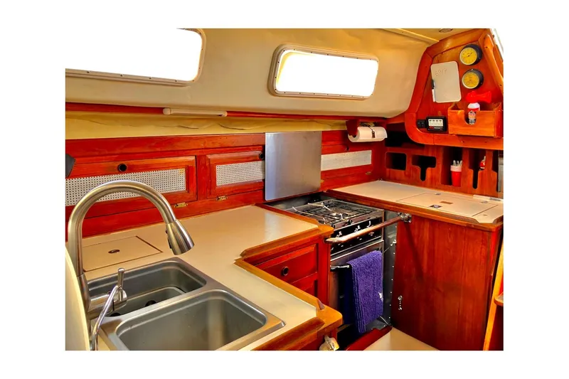 Slide: The Image of Interior of 1981 Jensen Marine/Cal Boats 39 MK III, featuring a compact kitchen area. - 51