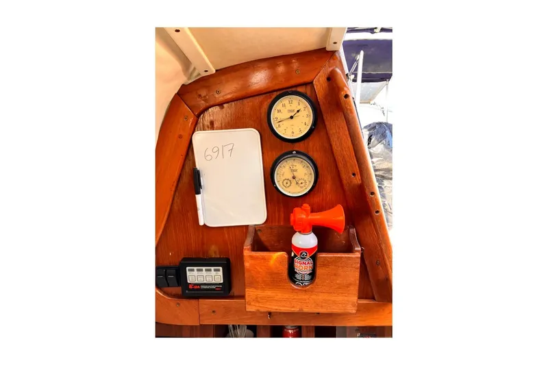 Slide: The Image of 1981 Jensen Marine/Cal Boats 39 MK III dashboard with gauges, air horn, and whiteboard. - 55