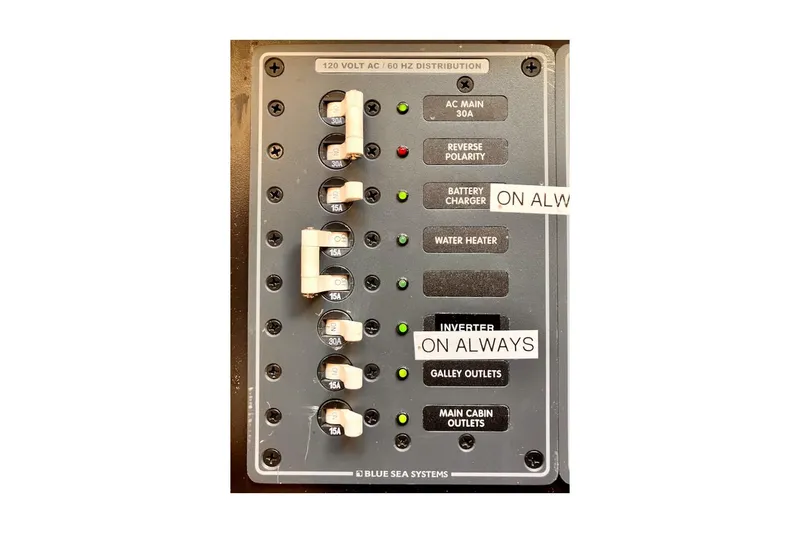 Slide: The Image of Electrical panel of 1981 Jensen Marine/Cal Boats 39 MK III, featuring circuit breakers and labels. - 59
