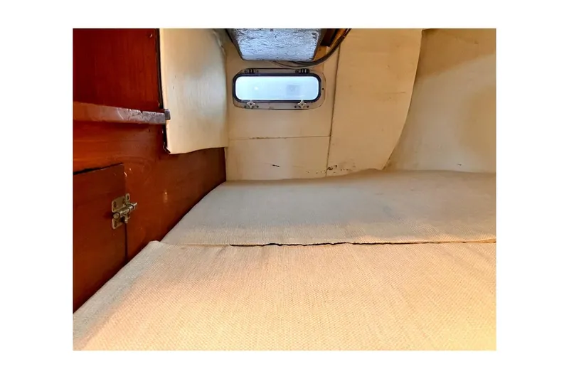 Slide: The Image of Interior cabin of 1981 Jensen Marine/Cal Boats 39 MK III sailboat, featuring wooden and fabric elements. - 67