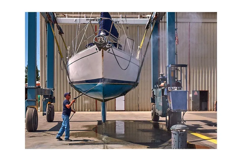 Slide: The Image of 1981 Jensen Marine/Cal Boats 39 MK III sailboat being cleaned at a shipyard. - 78