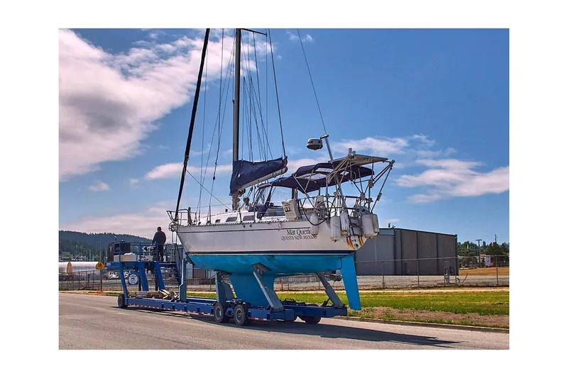Slide: The Image of 1981 Jensen Marine/Cal Boats 39 MK III sailboat on trailer under blue sky. - 79