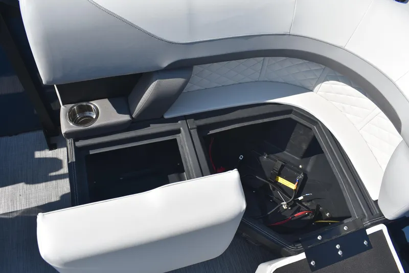 Slide: The Image of 2026 Lowe SS 230 WV boat interior with open storage compartment and cup holder. - 10