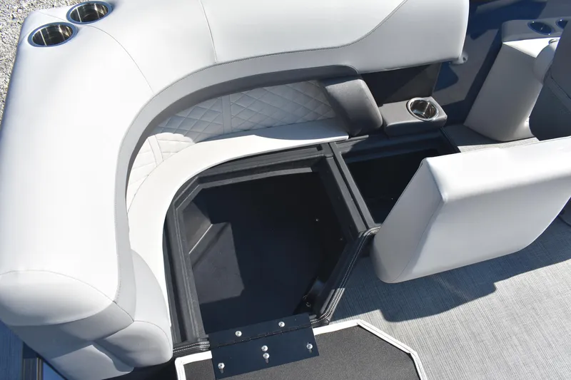 Slide: The Image of 2026 Lowe SS 230 WV boat interior with storage compartment and cup holders. - 12