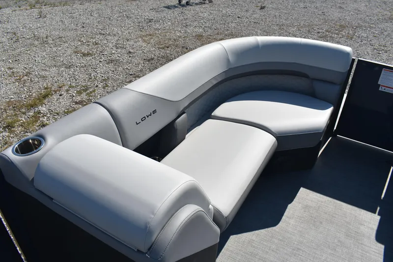 Slide: The Image of 2026 Lowe SS 230 WV boat seating with gray upholstery and cup holder on gravel surface. - 18
