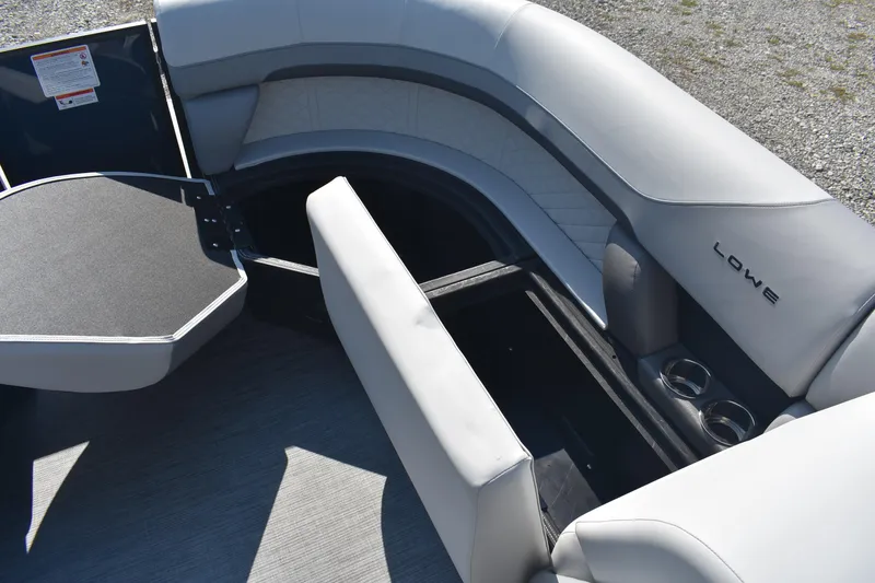 Slide: The Image of 2026 Lowe SS 230 WV boat interior with open storage and cup holders. - 21