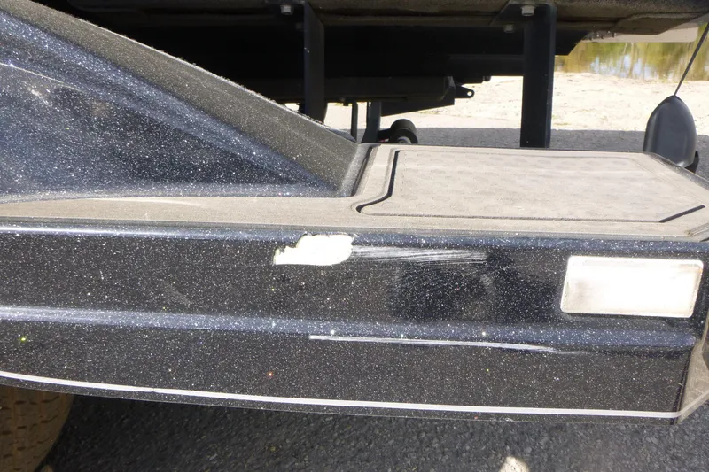 Slide: The Image of 2023 Nitro ZV21 boat with minor hull damage, close-up view. - 15