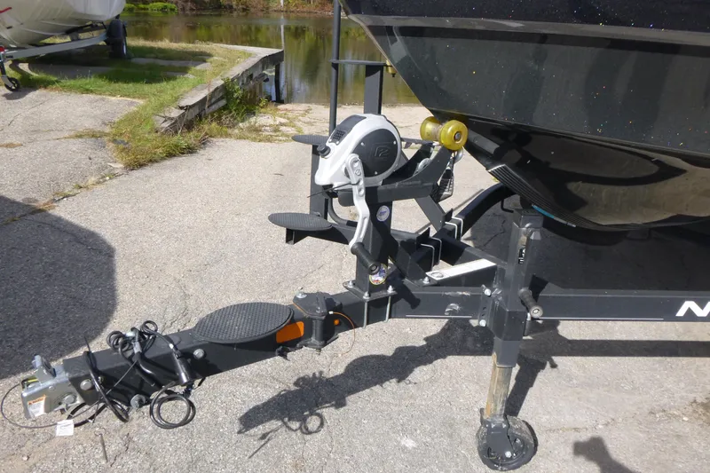 Slide: The Image of Trailer hitch of 2023 Nitro ZV21 boat on pavement near water. - 20