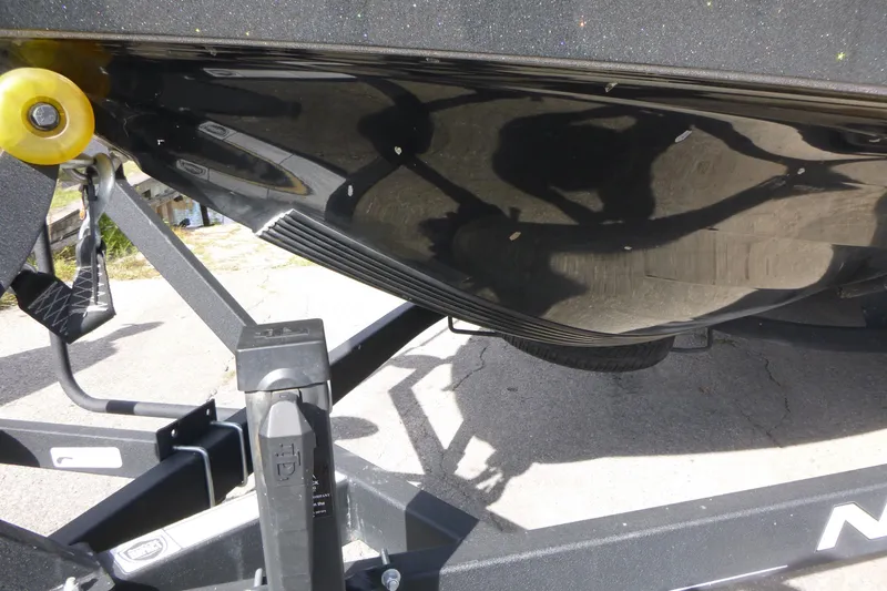 Slide: The Image of 2023 Nitro ZV21 boat hull on trailer, showcasing sleek black design. - 22