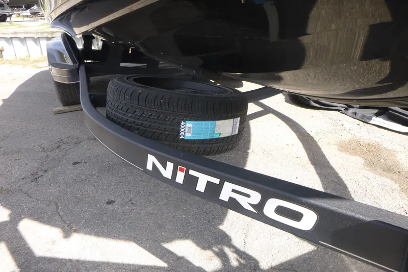 Slide: The Image of 2023 Nitro ZV21 boat trailer with spare tire on concrete surface. - 23