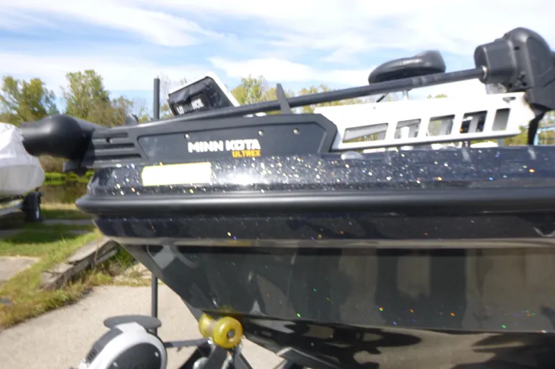 Slide: The Image of 2023 Nitro ZV21 boat with Minn Kota Ultrex motor, parked outdoors. - 34