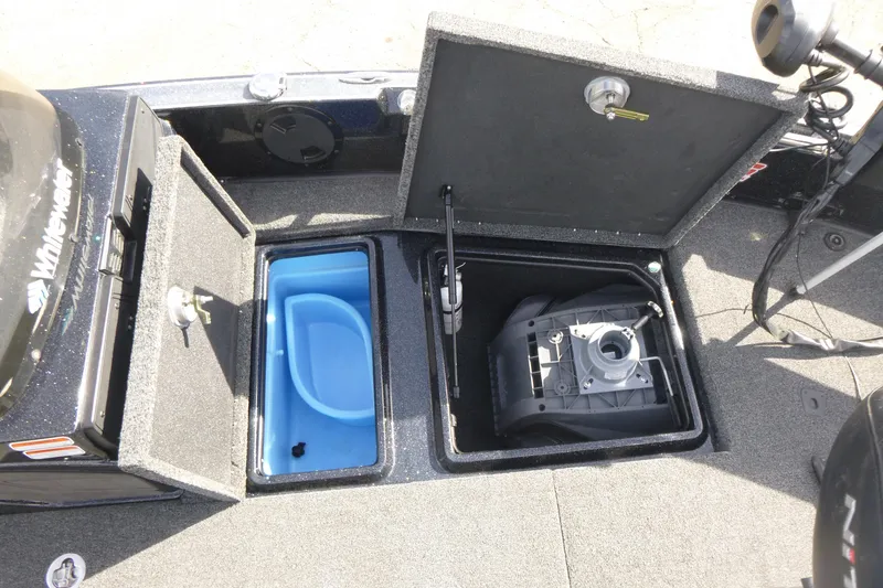 Slide: The Image of 2023 Nitro ZV21 boat storage compartments with blue container and mechanical equipment. - 35