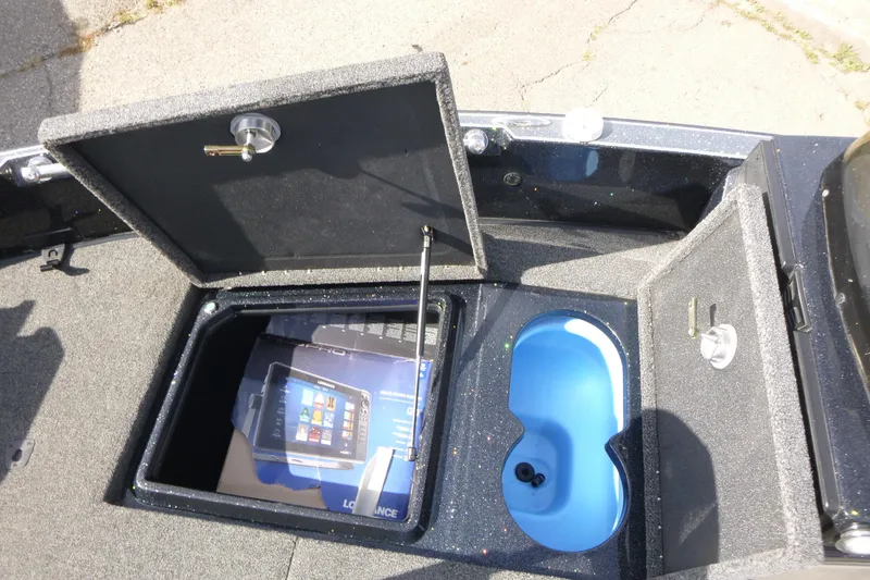 Slide: The Image of 2023 Nitro ZV21 boat storage compartments with open hatches and blue interior. - 36