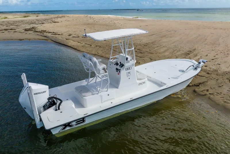The Image of 2026 Shallow Sport 25 X3 boat on trailer, parked outdoors under cloudy sky. - 0