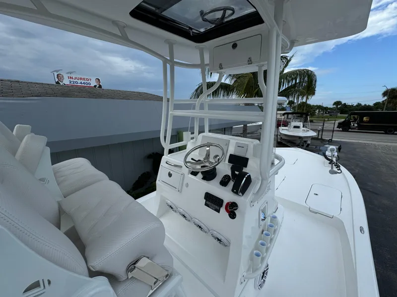 Slide: The Image of 2025 Shallow Sport 25 X3 boat console with steering wheel and controls. - 10