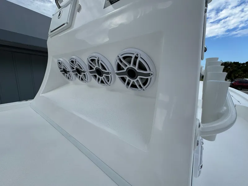 Slide: The Image of 2026 Shallow Sport 25 X3 boat on display under cloudy skies. - 13