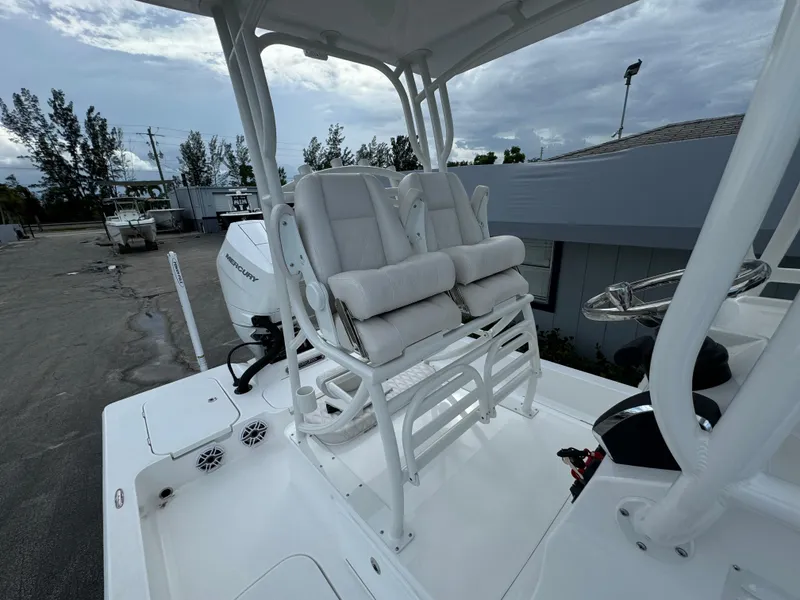 Slide: The Image of 2026 Shallow Sport 25 X3 boat with elevated helm, under cloudy sky. - 14