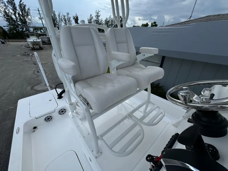 Slide: The Image of 2025 Shallow Sport 25 X3 boat storage compartment with open door. - 15