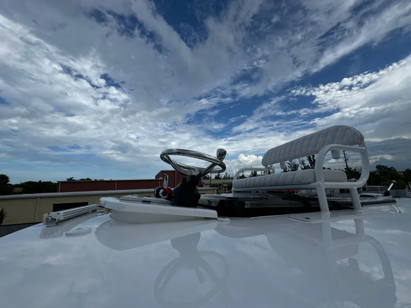 Slide: The Image of 2025 Shallow Sport 25 X3 boat with open hatch and clear sky. - 17