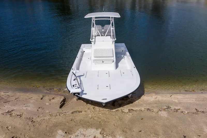 Slide: The Image of 2026 Shallow Sport 25 X3 boat with Mercury engine on trailer, parked outdoors. - 4