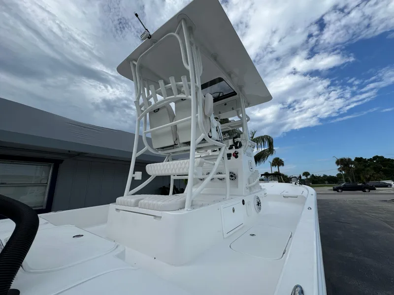 Slide: The Image of 2026 Shallow Sport 25 X3 boat with wet deck and ladder in rainy weather. - 6