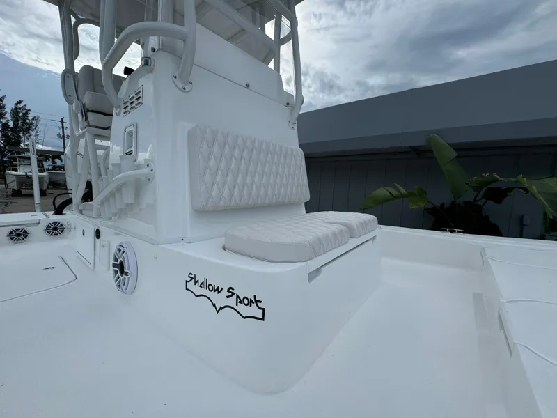 Slide: The Image of 2026 Shallow Sport 25 X3 boat with Mercury engine, docked under cloudy skies. - 8