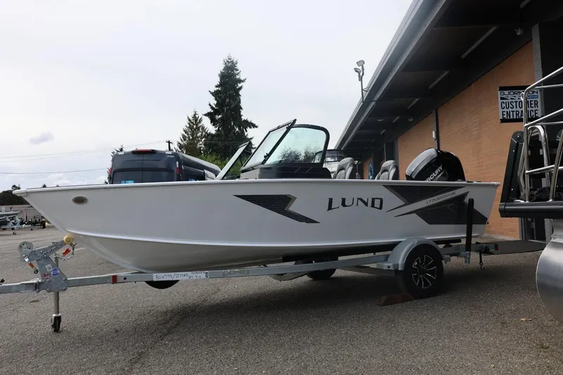 Slide: The Image of 2026 Lund 1775 Adventure Sport boat on trailer, parked outside dealership. - 10