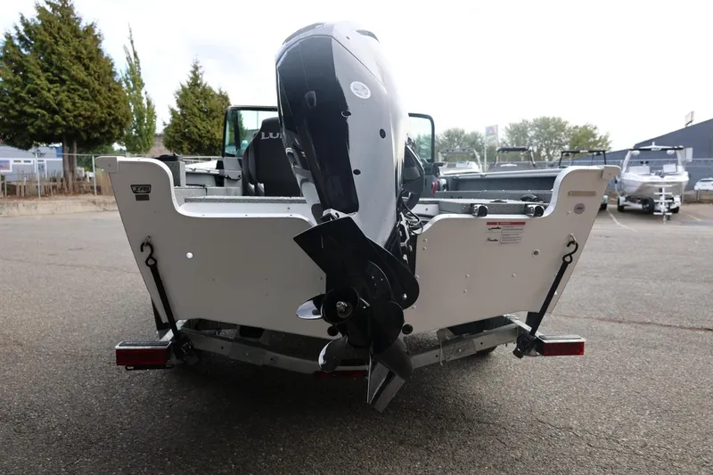 Slide: The Image of 2026 Lund 1775 Adventure Sport boat rear view with motor in parking lot. - 14