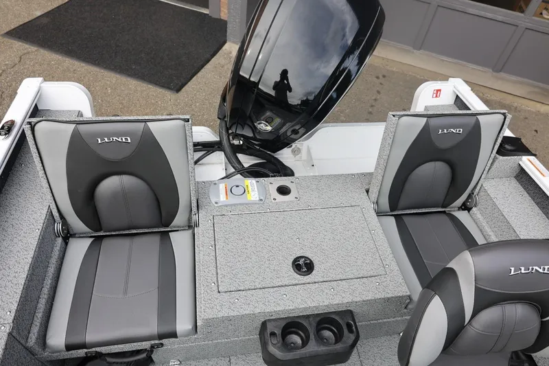 Slide: The Image of 2026 Lund 1775 Adventure Sport boat interior with gray seating and motor. - 18