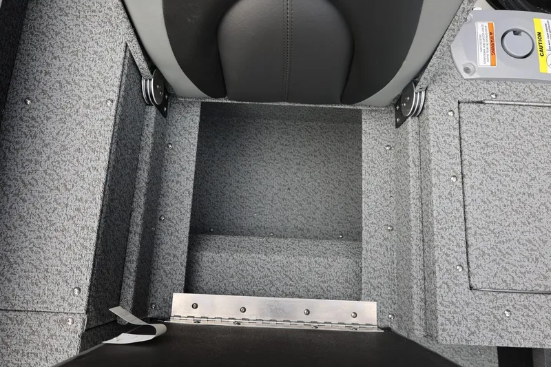 Slide: The Image of 2026 Lund 1775 Adventure Sport boat interior with gray textured flooring and seating. - 19