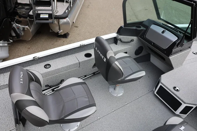 Slide: The Image of 2026 Lund 1775 Adventure Sport boat interior with two swivel seats and console. - 22