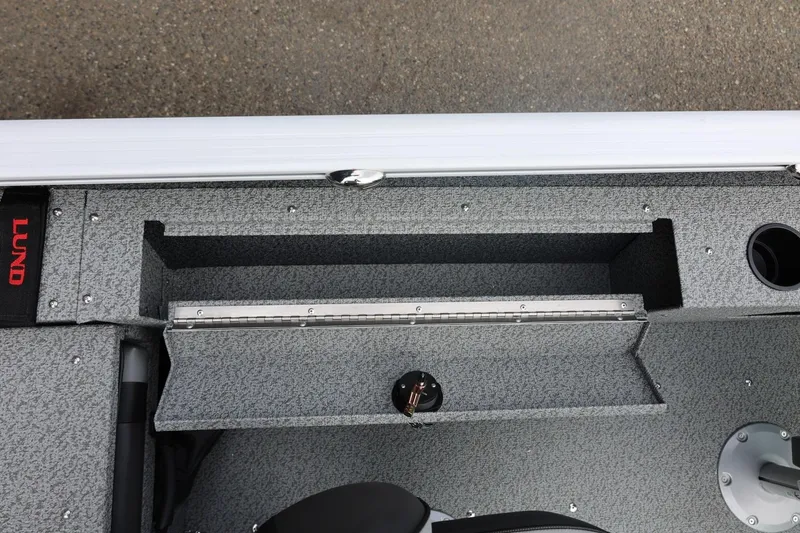 Slide: The Image of 2026 Lund 1775 Adventure Sport boat interior with storage compartment and cup holder. - 23