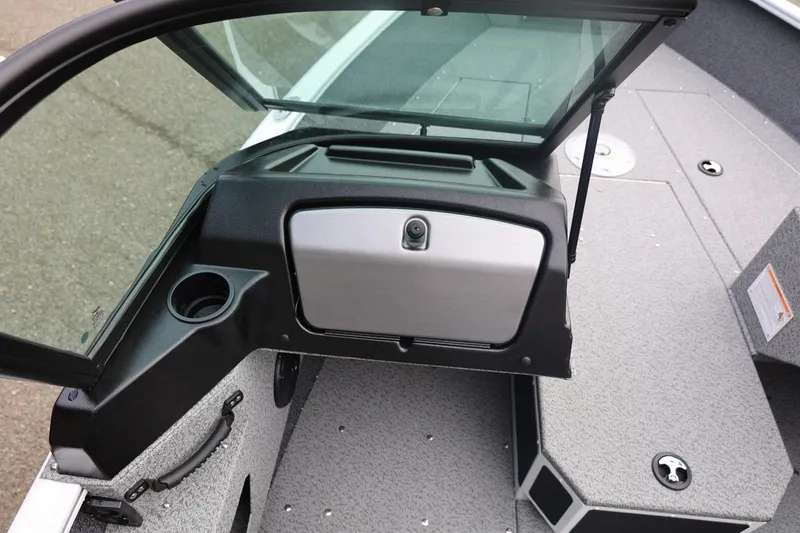 Slide: The Image of 2026 Lund 1775 Adventure Sport boat interior with open storage compartment and cup holder. - 25