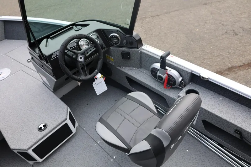 Slide: The Image of 2026 Lund 1775 Adventure Sport boat interior with steering wheel and seating. - 28