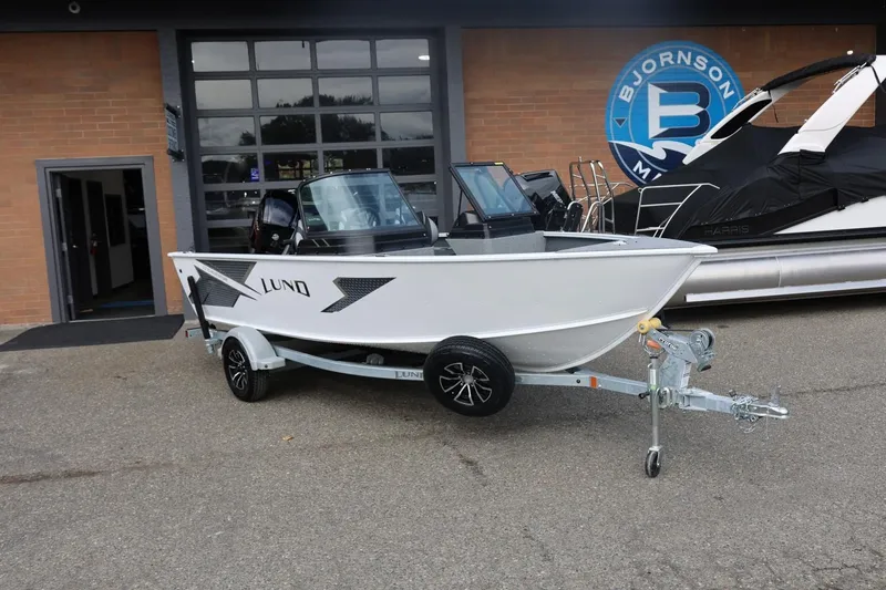 Slide: The Image of 2026 Lund 1775 Adventure Sport boat on trailer outside dealership. - 3