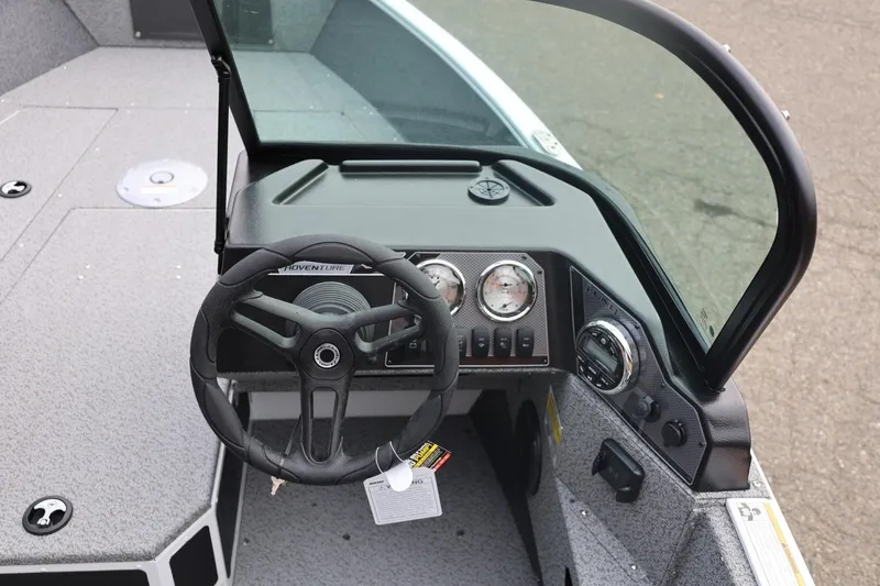 Slide: The Image of 2026 Lund 1775 Adventure Sport boat dashboard with steering wheel and gauges. - 30
