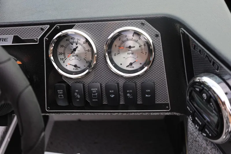 Slide: The Image of Dashboard of 2026 Lund 1775 Adventure Sport boat with gauges and control switches. - 31