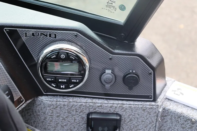 Slide: The Image of Control panel of 2026 Lund 1775 Adventure Sport boat with audio system and power outlets. - 32