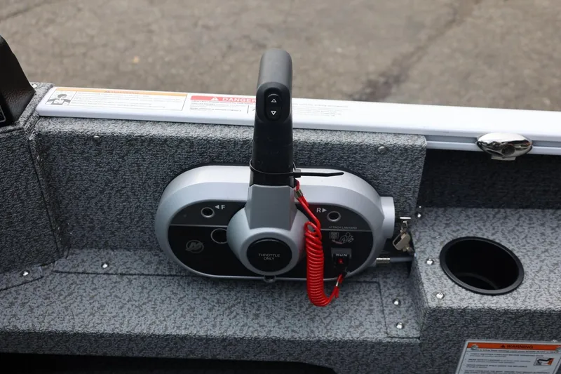 Slide: The Image of 2026 Lund 1775 Adventure Sport boat throttle control with safety features and warning labels. - 33