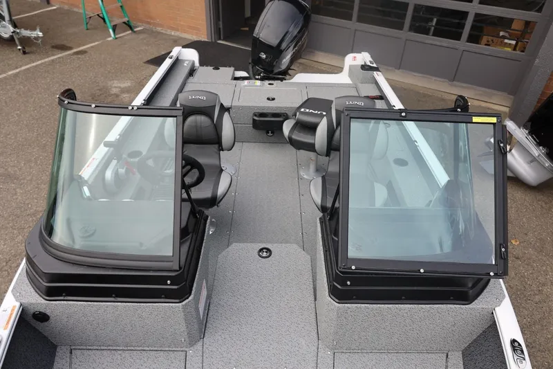 Slide: The Image of 2026 Lund 1775 Adventure Sport boat interior with dual consoles and seating. - 38