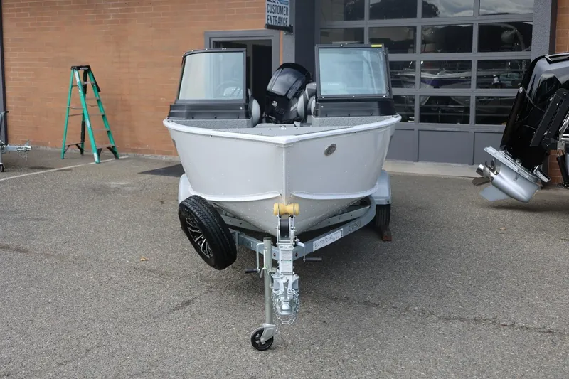 Slide: The Image of 2026 Lund 1775 Adventure Sport boat on trailer, parked outside a building. - 5