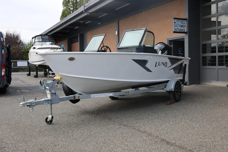Slide: The Image of 2026 Lund 1775 Adventure Sport boat on trailer outside dealership. - 8