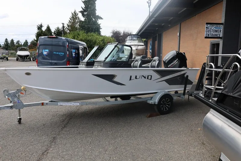 Slide: The Image of 2026 Lund 1775 Adventure Sport boat on trailer outside dealership. - 9