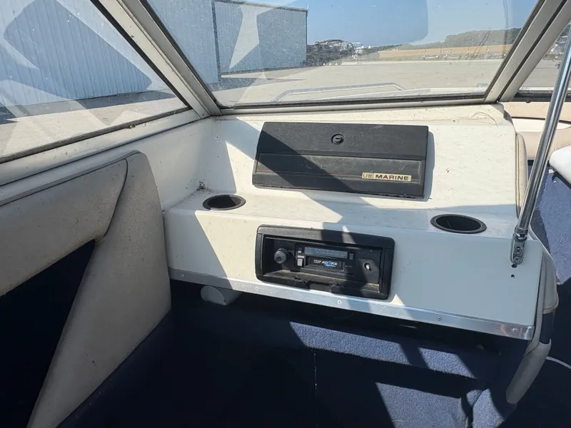 Slide: The Image of Interior of a 1996 Bayliner CAPRI boat showing dashboard and seating area. - 4