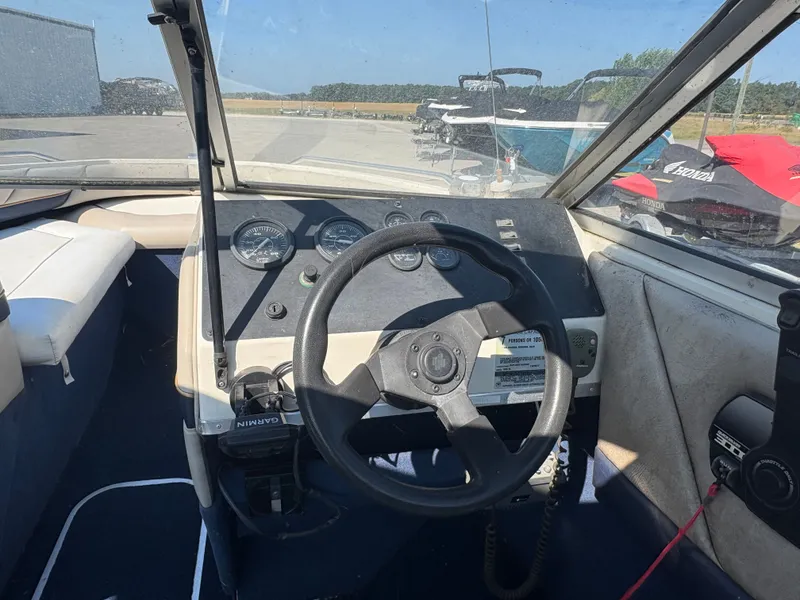 Slide: The Image of 1996 Bayliner CAPRI boat dashboard with steering wheel and gauges. - 7
